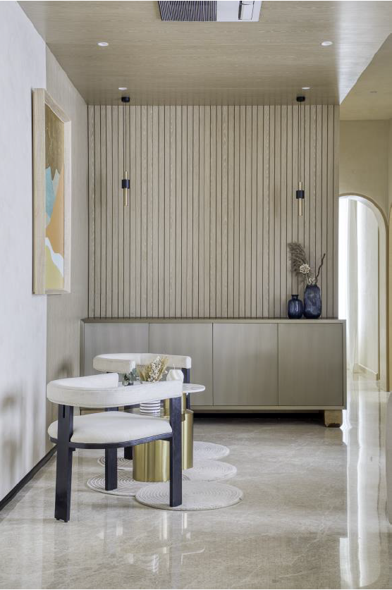 Modern interior featuring a minimalist design with a wooden accent wall, stylish seating, and decorative elements.