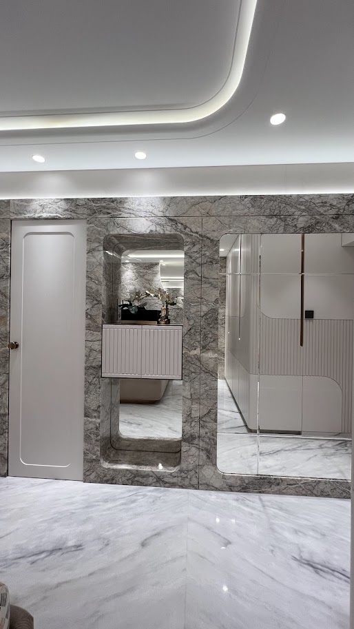 Modern interior design featuring marble walls, sleek cabinetry, and elegant lighting in a stylish space.