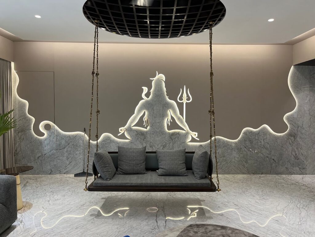 Modern interior featuring a swing seat against a backlit marble wall with a silhouette design.