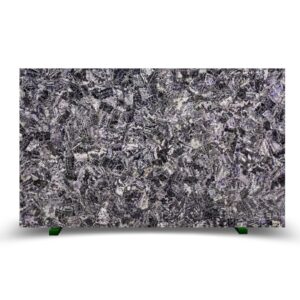 Textured surface of dark stone with intricate veining in shades of purple and gray, evoking a mythic presence.